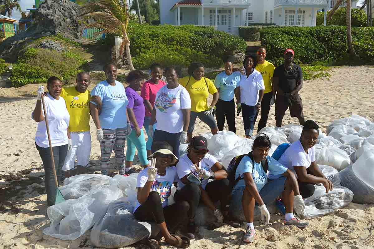 The Sandals Foundation cleaning up a beach in the Caribbean