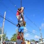 Men climbing pole