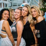 4 women posing at party